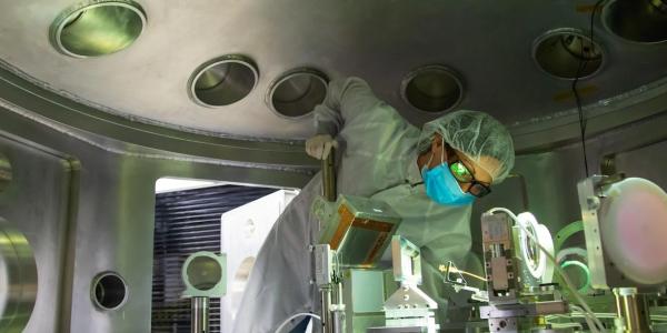 A scientist checks alignment of a detector in the MEC target chamber