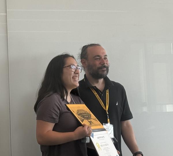 Megan Ikeya (left) receives her poster prize from Petros Tzeferacos (U. Rochester)