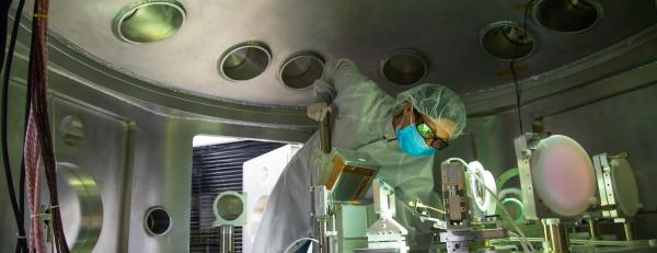 A scientist checks alignment of a detector in the MEC target chamber